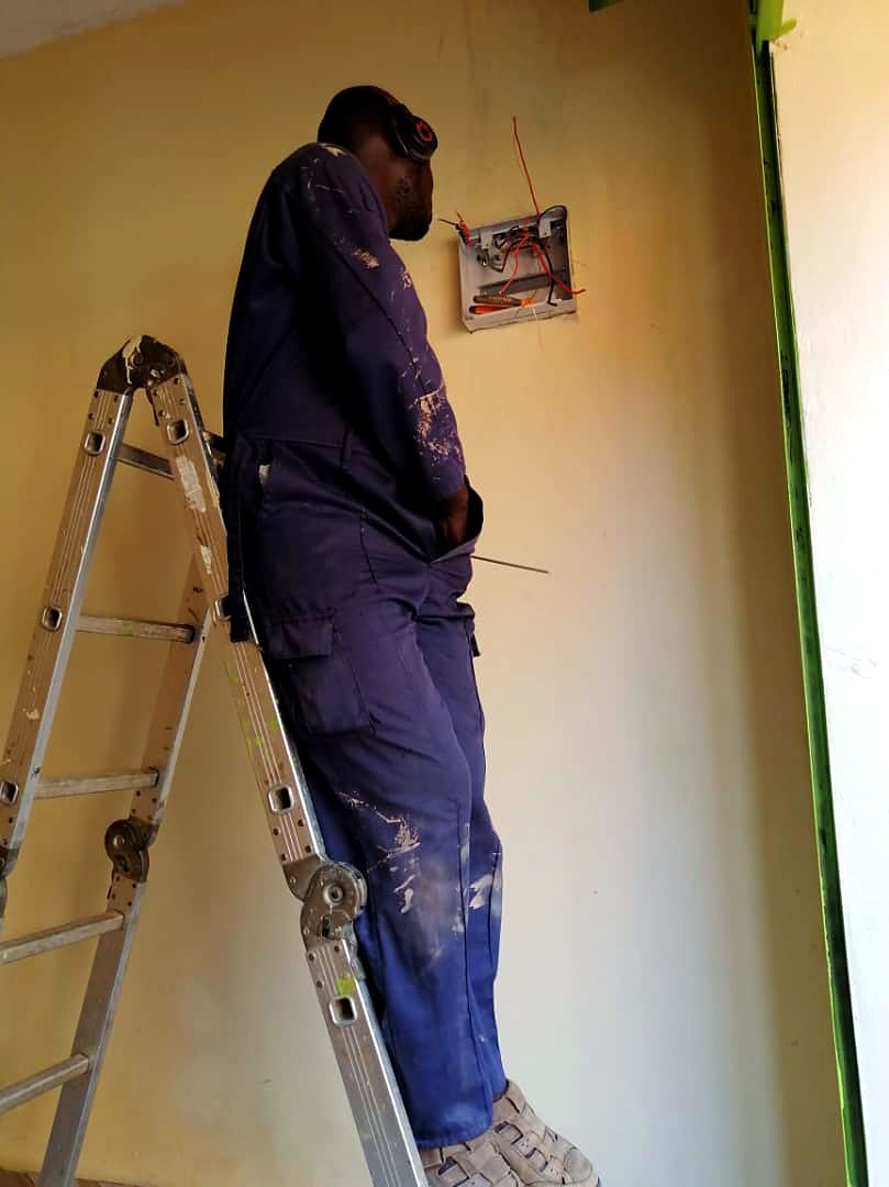 Technician finishing connections inside a distribution board
