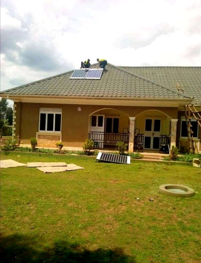 Bungalow with rooftop solar equipment and landscaped compound