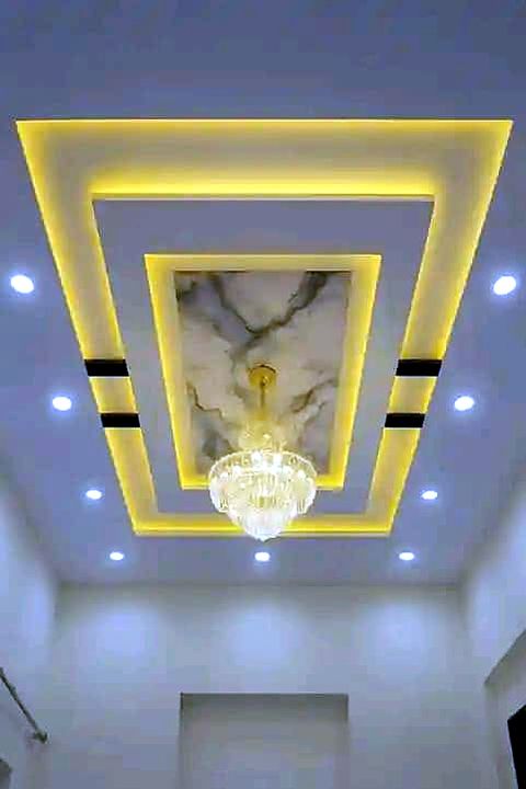 Gold LED cove lighting in a decorative gypsum ceiling with a chandelier