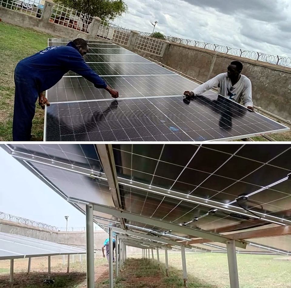 Ground-mounted solar array being installed on raised frames