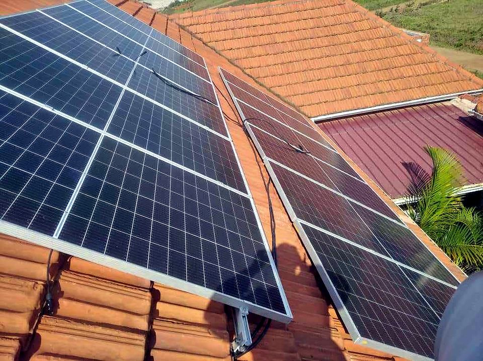 Solar panels mounted on rails across a tiled roof